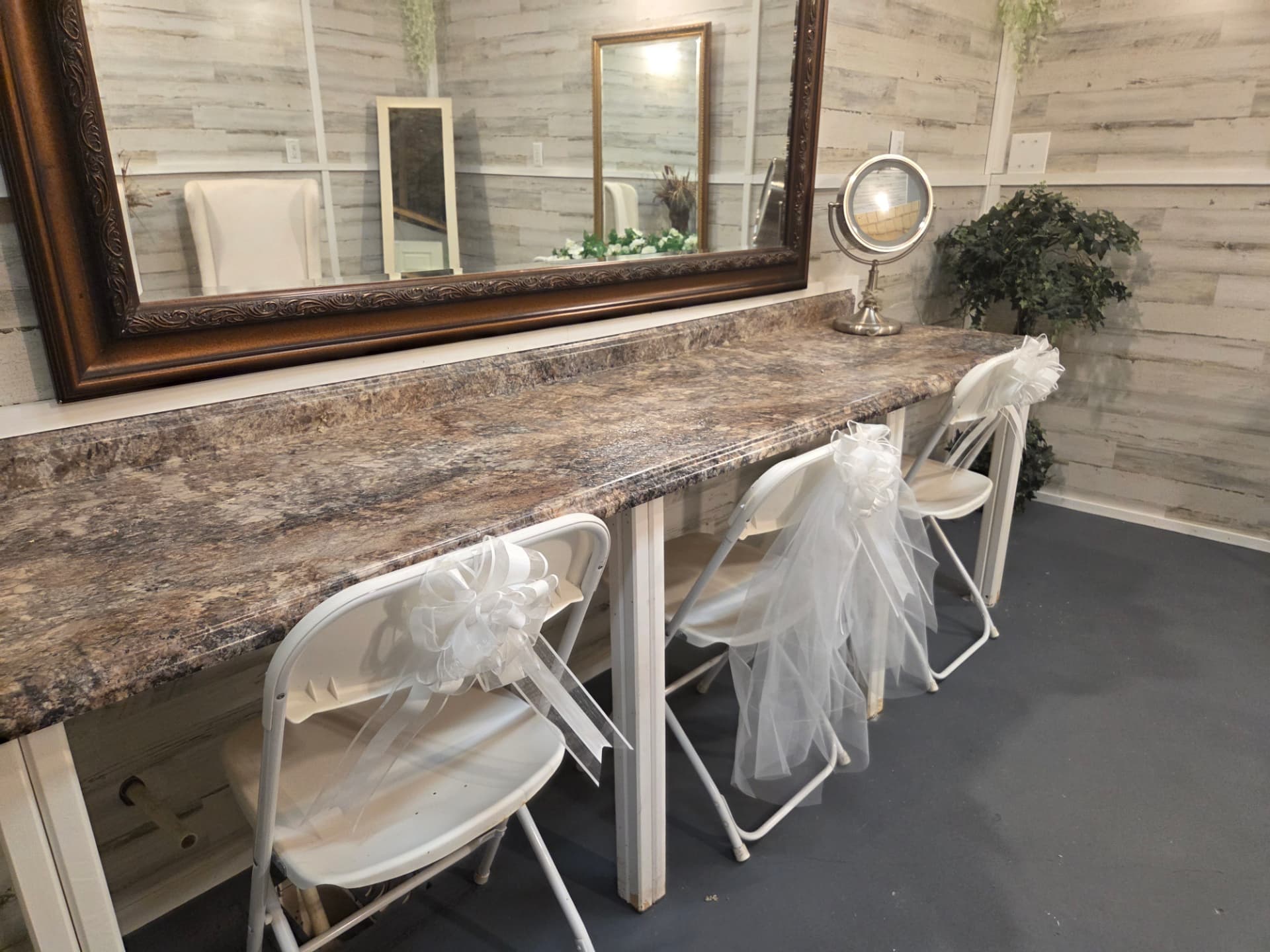 Bridal suite vanity counter with framed mirror and getting-ready seating